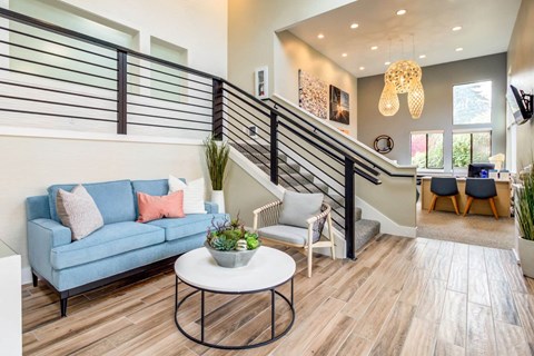 a living room with a blue couch and a white table